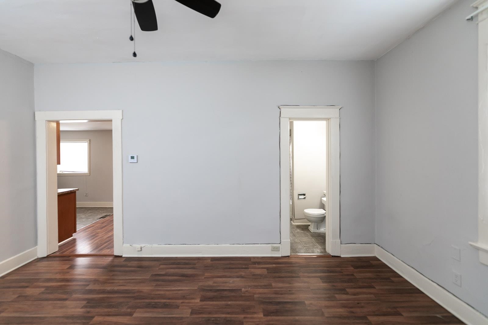 1515 Madison Avenue Memphis, TN 38104 - Photo 7 of 19 a view of an empty room with wooden floor and a window