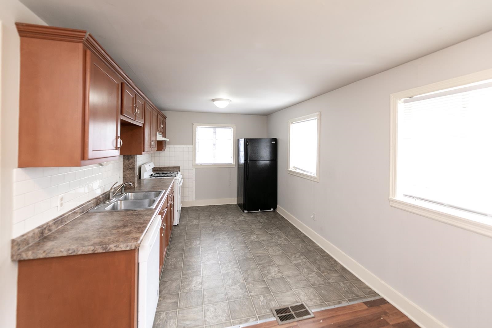 1515 Madison Avenue Memphis, TN 38104 - Photo 9 of 19 a kitchen with granite countertop a refrigerator stove oven sink and cabinets