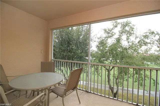 a view of a chair and table in the balcony