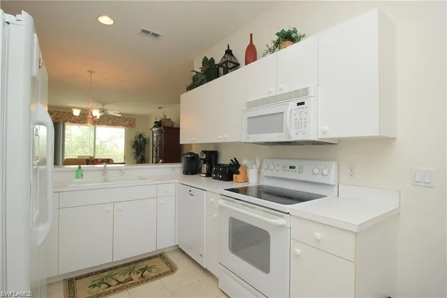 a kitchen with a sink a stove and cabinets