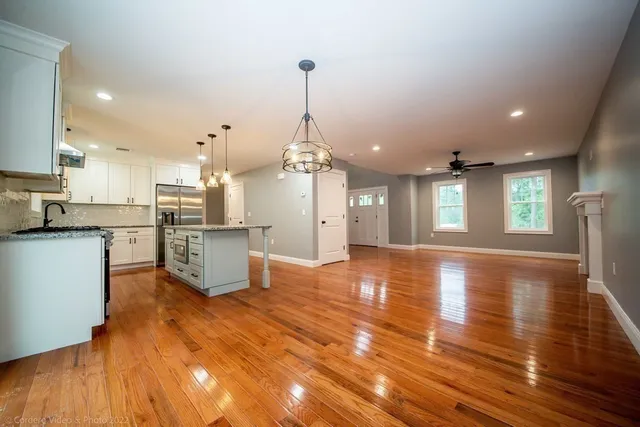 a view of a kitchen with cabinets and wooden floor