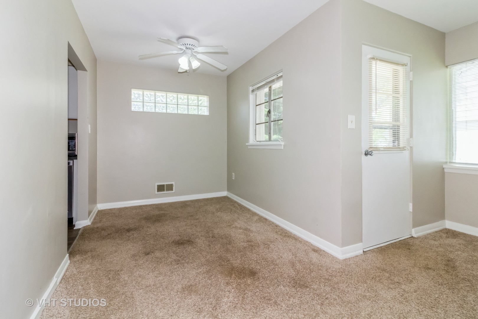 903 North 13th Street DeKalb, IL 60115 - Photo 7 of 19 an empty room with windows and fan