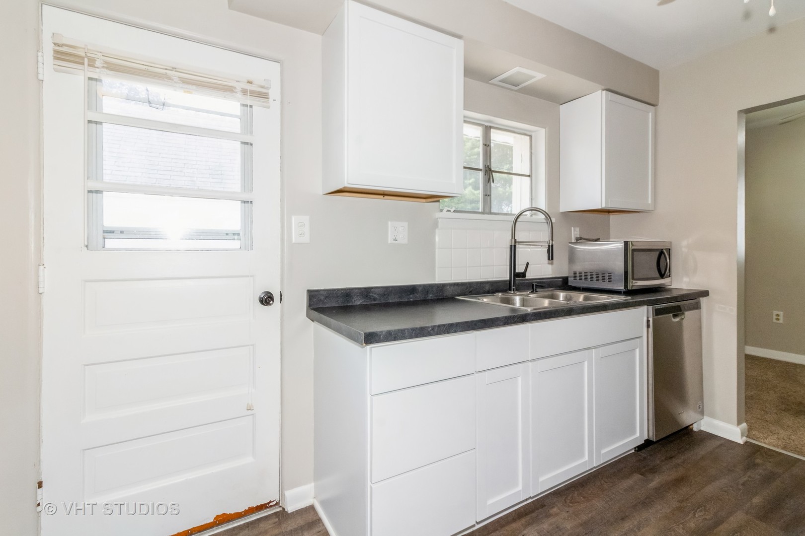 903 North 13th Street DeKalb, IL 60115 - Photo 10 of 19 a kitchen with granite countertop white cabinets and white appliances