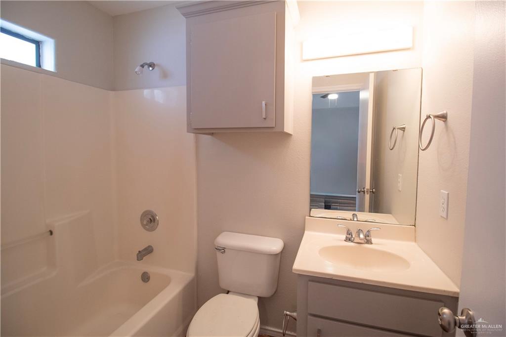 708 Robin Avenue, Unit 3 McAllen, TX 78504 - Photo 6 of 10 a bathroom with a sink toilet and shower