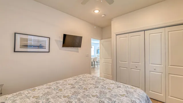 a bedroom with a bed and a flat screen tv