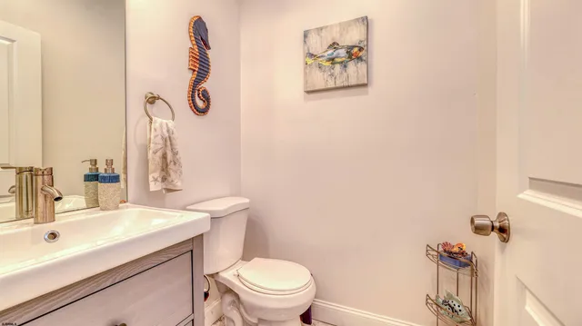 a bathroom with a sink mirror vanity and toilet