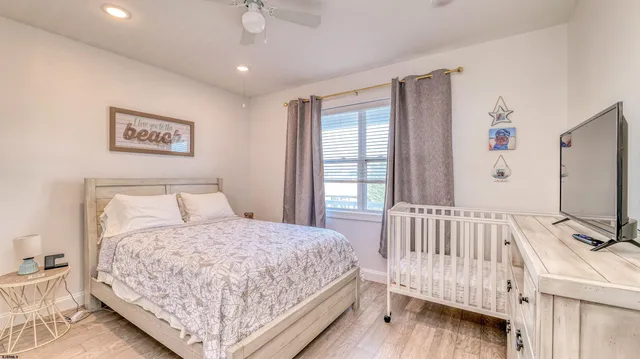 a bedroom with a bed window and a flat screen tv