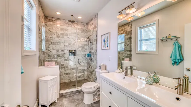 a bathroom with a sink a toilet a tub and shower