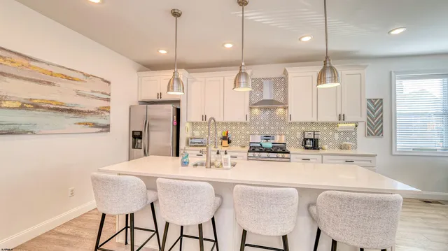 a large kitchen with a table and chairs