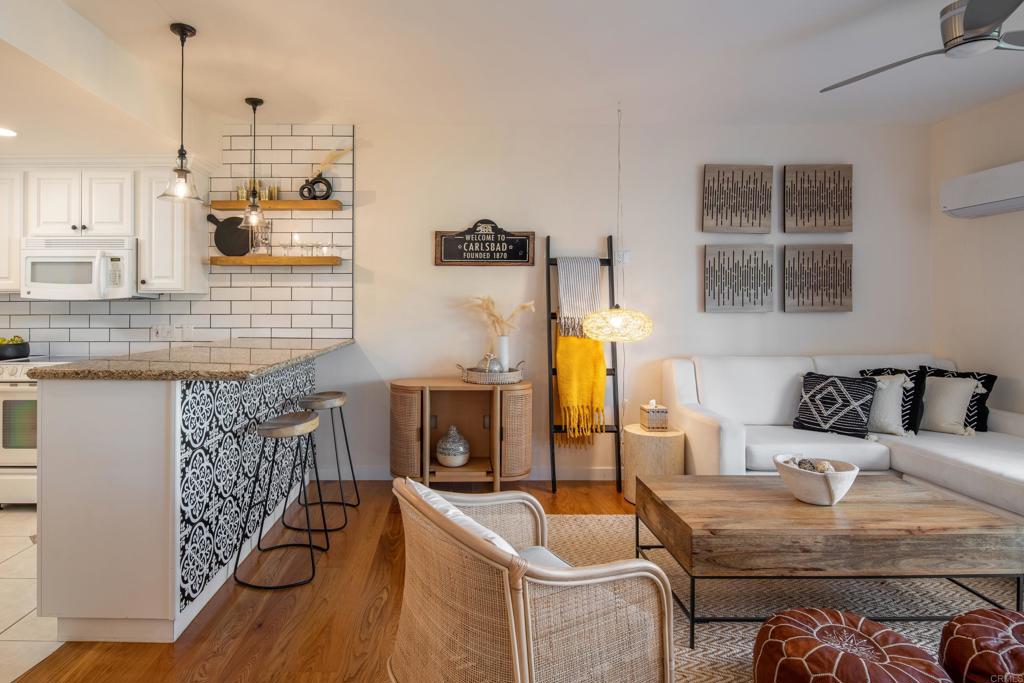 2005 Costa Del Mar Road, Unit 627 Carlsbad, CA 92009 - Photo 12 of 21 a living room with furniture and a fireplace
