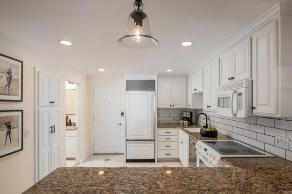 a kitchen with stainless steel appliances granite countertop a sink and cabinets