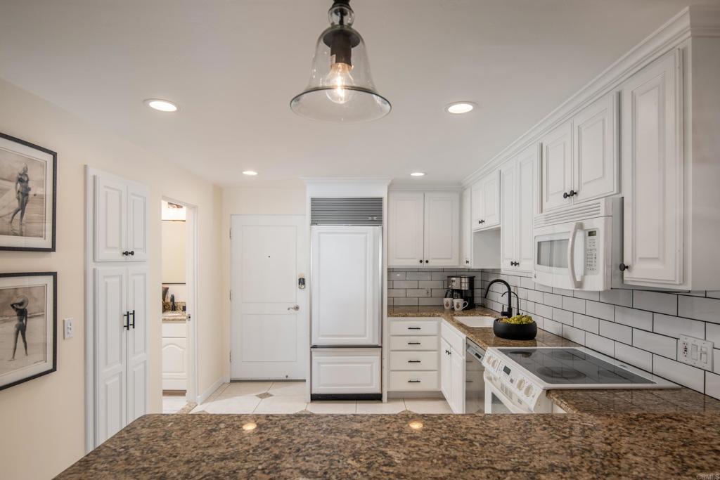 2005 Costa Del Mar Road, Unit 627 Carlsbad, CA 92009 - Photo 16 of 21 a kitchen with stainless steel appliances granite countertop a sink and cabinets