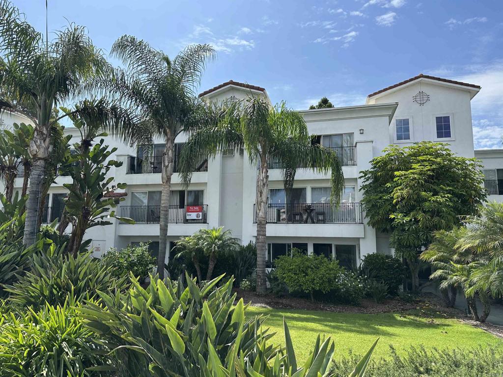 2005 Costa Del Mar Road, Unit 627 Carlsbad, CA 92009 - Photo 2 of 21 a front view of a house with a garden