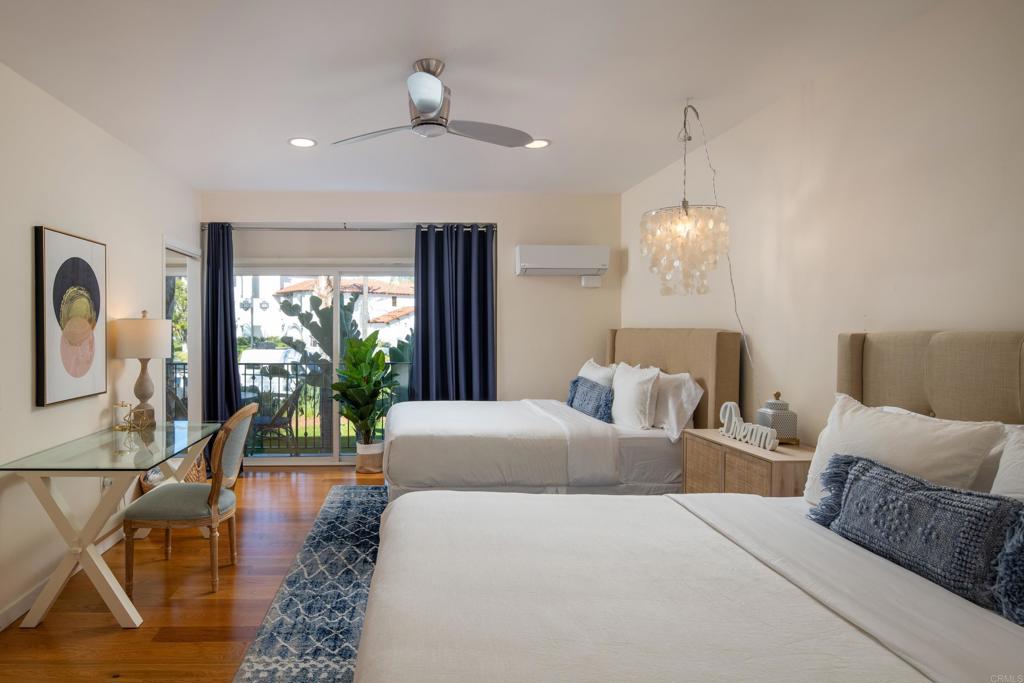 2005 Costa Del Mar Road, Unit 627 Carlsbad, CA 92009 - Photo 7 of 21 a living room with furniture and a chandelier
