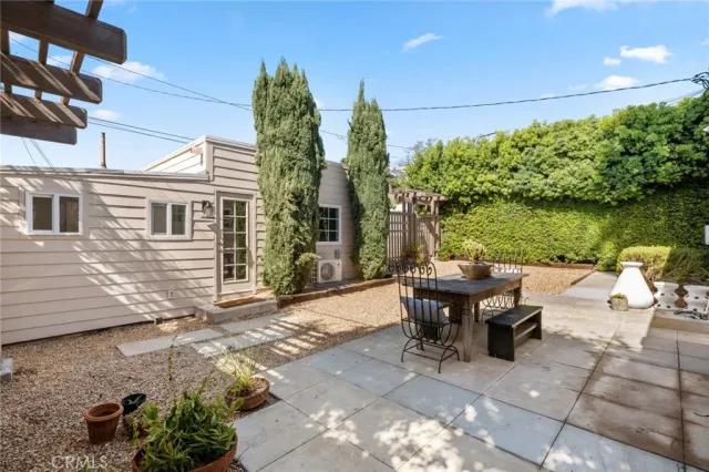 a backyard of a house with outdoor seating