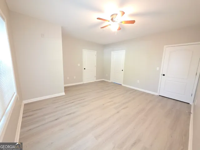 a view of a room with wooden floor
