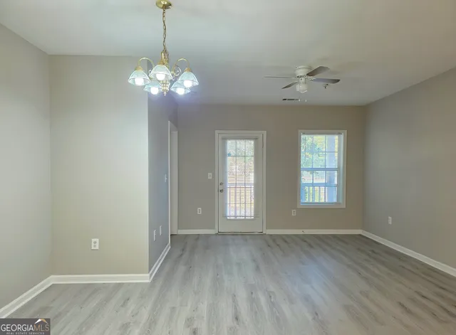 a view of a room with wooden floor