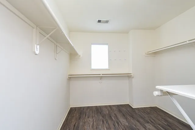 a view of a room with wooden floor and white walls