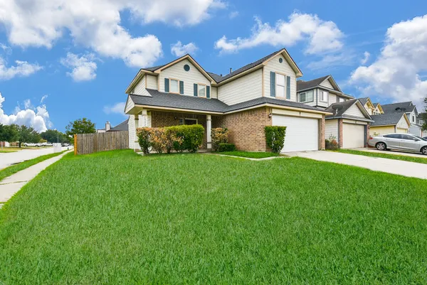 a front view of house with yard and green space