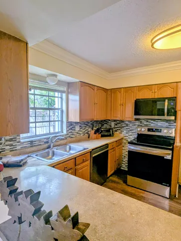 a kitchen with stainless steel appliances granite countertop a stove and a sink