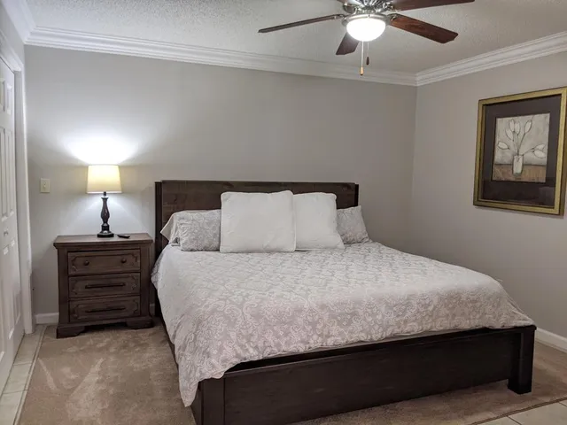 a large bed sitting in a bedroom next to a lamp