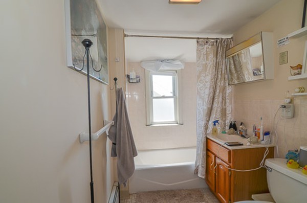 16 Kimball Road Watertown, MA 02472 - Photo 18 of 22 a bathroom with a tub sink and mirror