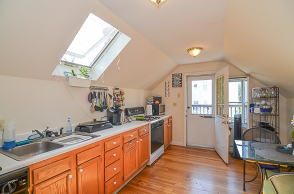 16 Kimball Road Watertown, MA 02472 - Photo 19 of 22 a kitchen with stainless steel appliances granite countertop a sink stove and wooden cabinets
