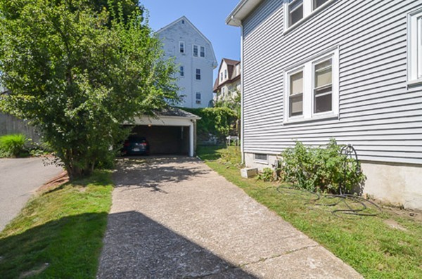 16 Kimball Road Watertown, MA 02472 - Photo 21 of 22 a front view of a house with a yard and a garage