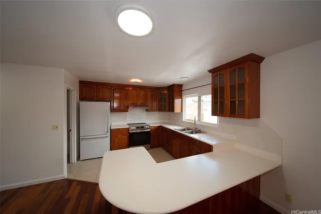 a kitchen that has a sink and a stove in it