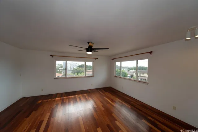 wooden floor in an empty room with a window