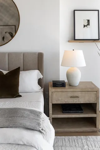 a view of a living room with racks on the wall and a window