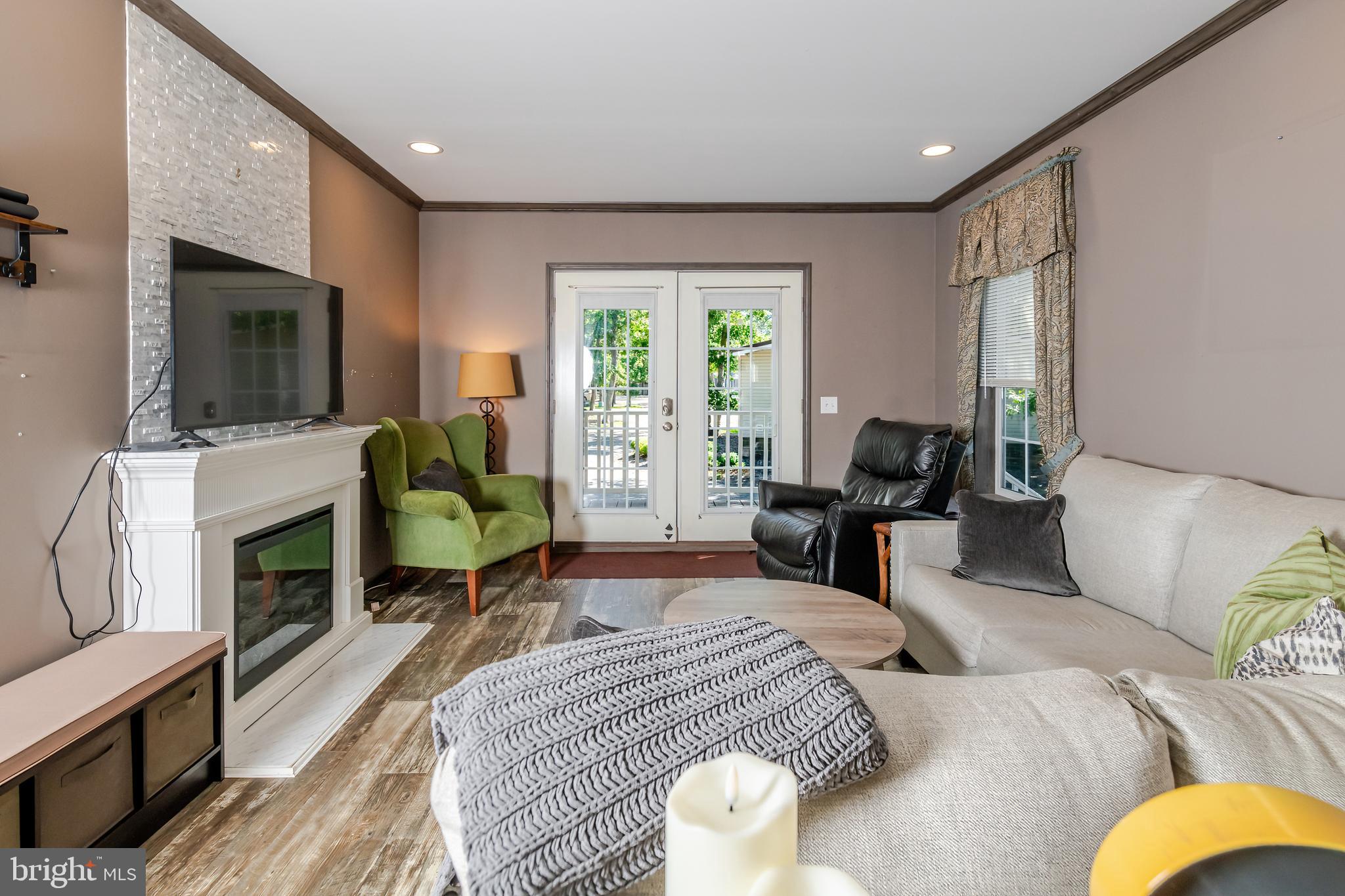 106 East Moss Mill Road, Unit T38 Galloway Township, NJ 08205 - Photo 16 of 28 a bedroom with furniture and a flat screen tv