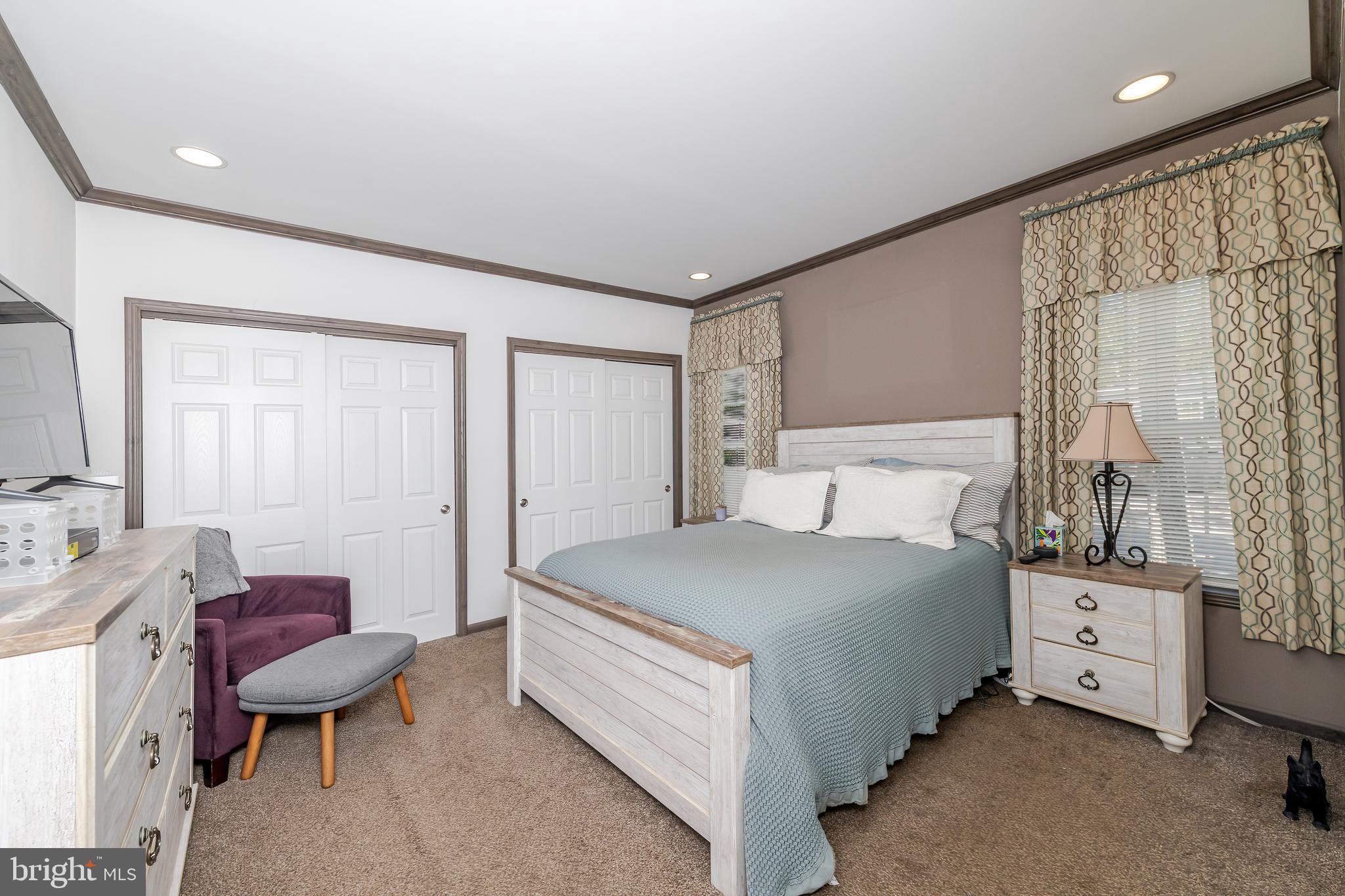 106 East Moss Mill Road, Unit T38 Galloway Township, NJ 08205 - Photo 18 of 28 a bedroom with a bed and a chair