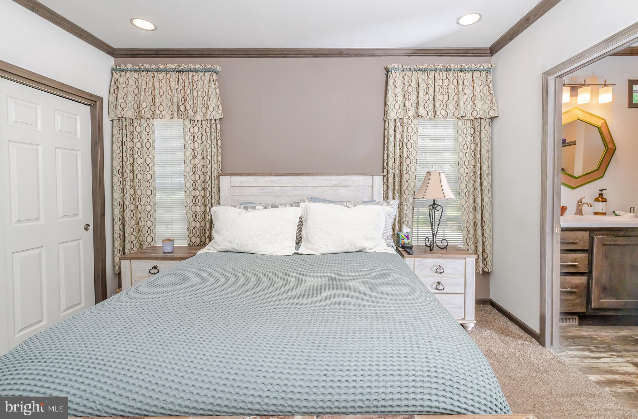 106 East Moss Mill Road, Unit T38 Galloway Township, NJ 08205 - Photo 20 of 28 a bedroom with a bed a mirror with the walls