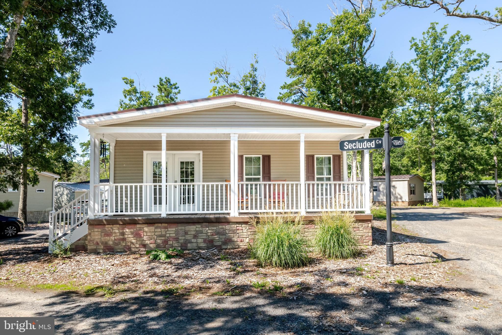 106 East Moss Mill Road, Unit T38 Galloway Township, NJ 08205 - Photo 2 of 28 a front view of a house with a yard and potted plants