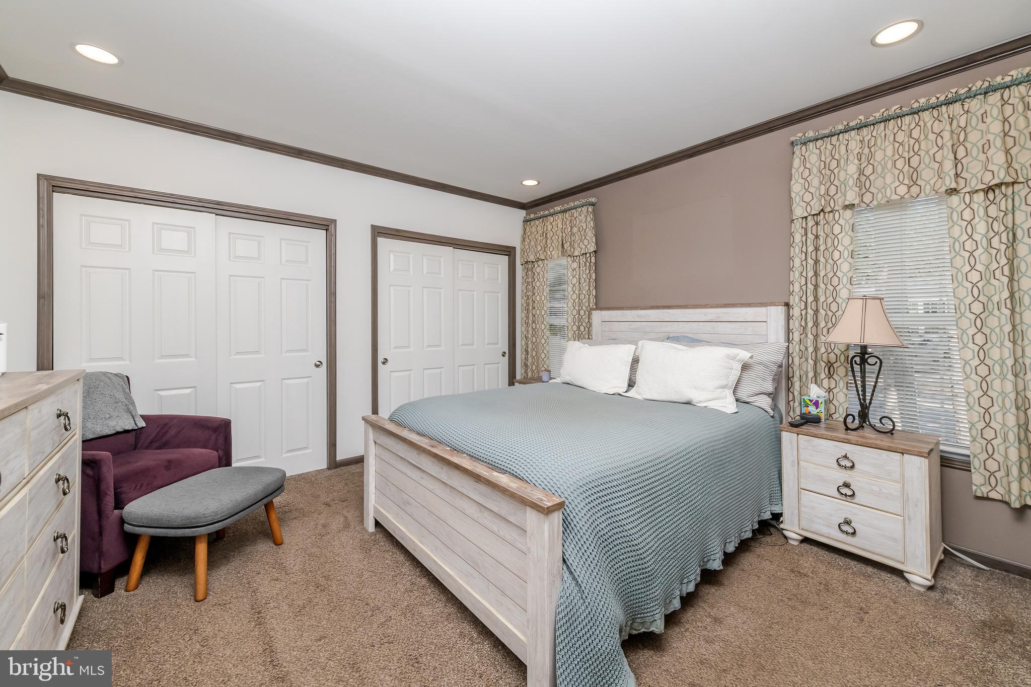 106 East Moss Mill Road, Unit T38 Galloway Township, NJ 08205 - Photo 21 of 28 a bedroom with a bed and a chair