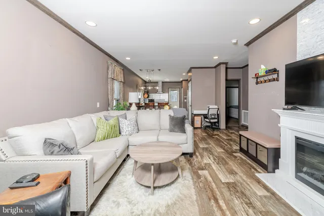 a view of a small house with yard and trees in the background