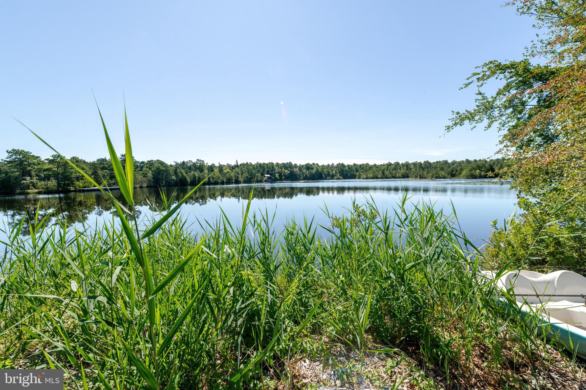 106 East Moss Mill Road, Unit T38 Galloway Township, NJ 08205 - Photo 26 of 28 a view of a lake with plants and large trees