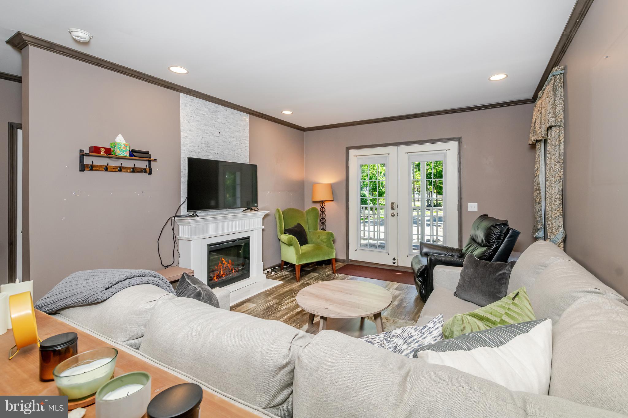 106 East Moss Mill Road, Unit T38 Galloway Township, NJ 08205 - Photo 6 of 28 a living room with furniture a fireplace and a flat screen tv