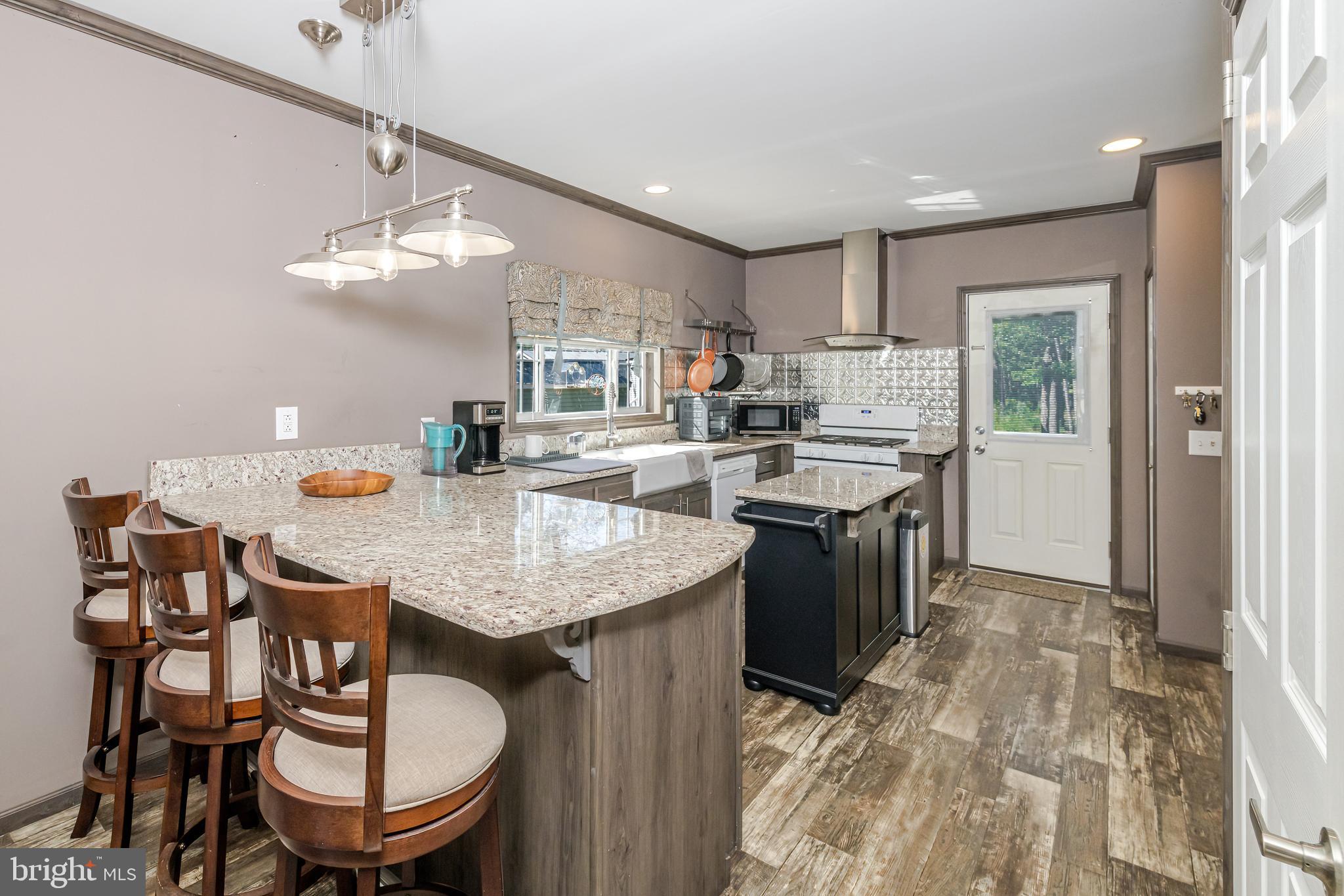 106 East Moss Mill Road, Unit T38 Galloway Township, NJ 08205 - Photo 8 of 28 a kitchen with a dining table chairs sink and stove