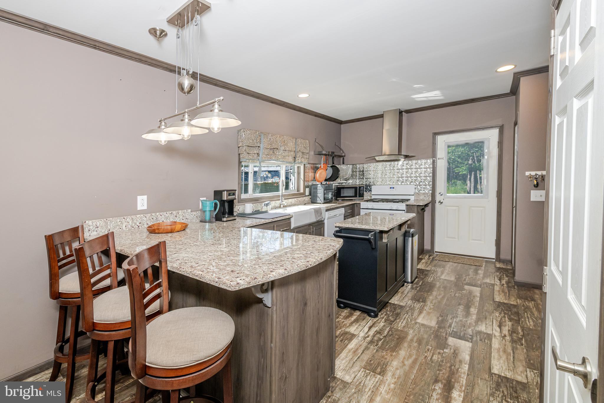 106 East Moss Mill Road, Unit T38 Galloway Township, NJ 08205 - Photo 9 of 28 a kitchen with a stove a table and chairs in it