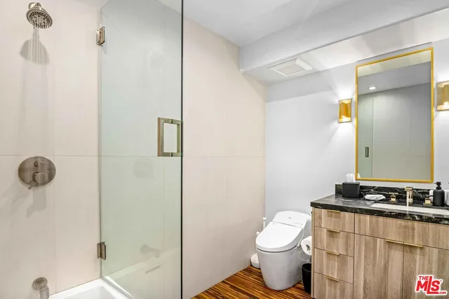 a bathroom with a toilet sink and shower