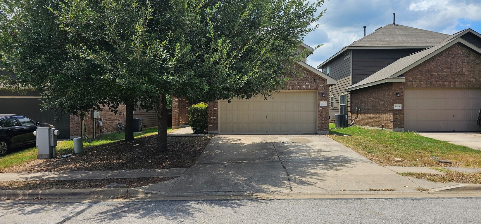 7213 Outfitter Drive Austin, TX 78744 - Photo 1 of 16 a view of a grey house with a yard