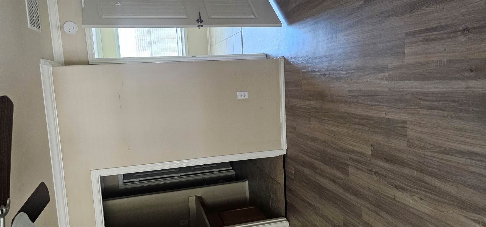 7213 Outfitter Drive Austin, TX 78744 - Photo 14 of 16 a view of an empty room with wooden floor and a window