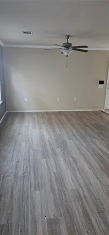 a view of a room with wooden floor