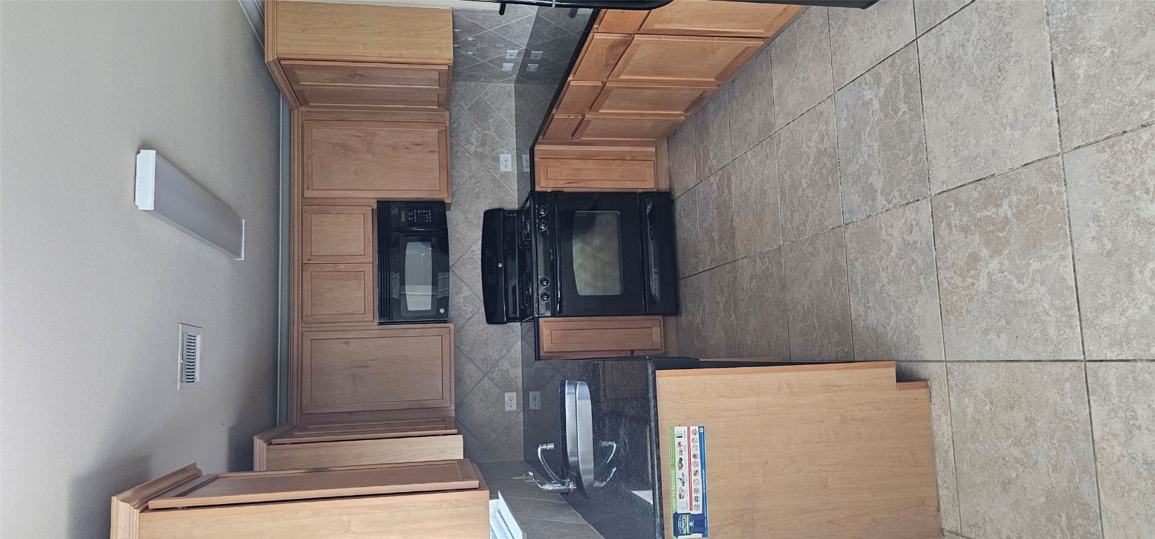 7213 Outfitter Drive Austin, TX 78744 - Photo 9 of 16 a kitchen with stainless steel appliances granite countertop a stove a sink and a microwave