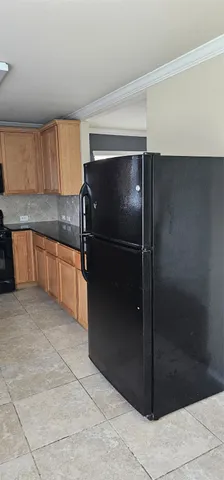a kitchen with a refrigerator and a sink