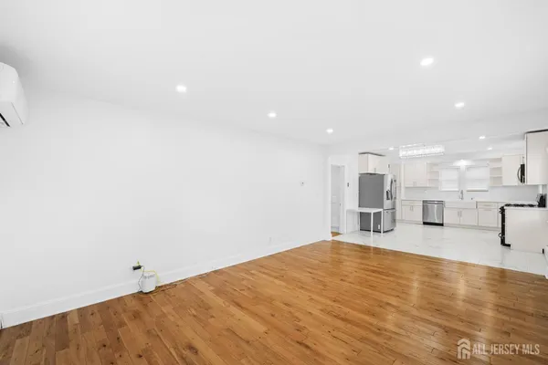 a view of a room with kitchen island a sink wooden floor and living room view