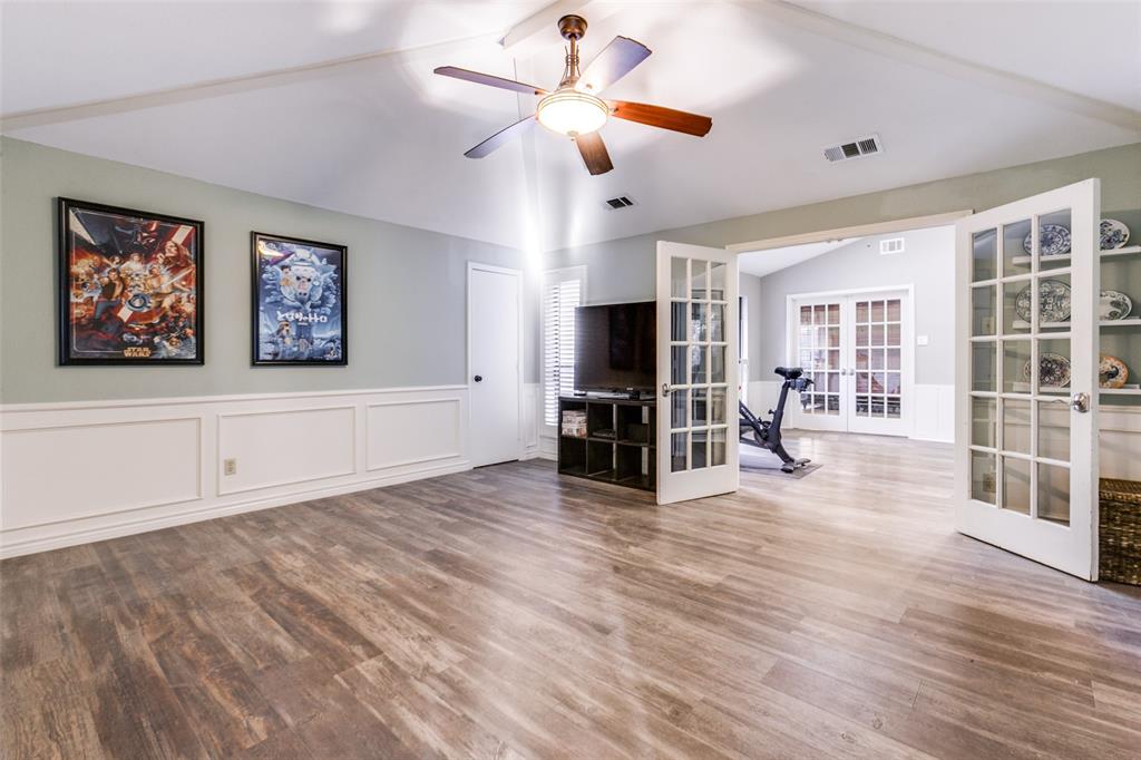 15881 Nedra Way Dallas, TX 75248 - Photo 12 of 26 a view of a livingroom with wooden floor and a ceiling fan