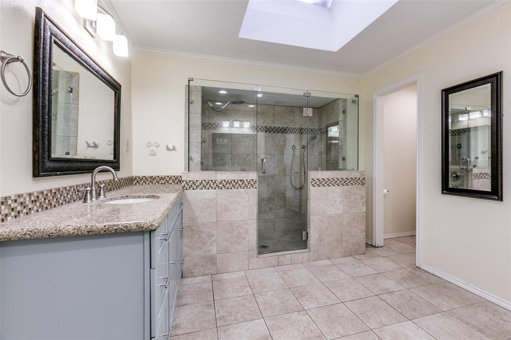 15881 Nedra Way Dallas, TX 75248 - Photo 16 of 26 a bathroom with a granite countertop sink and a mirror